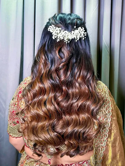The hairstyle for this look was soft, romantic waves, half-tied and decorated with a delicate baby's breath accessory.
