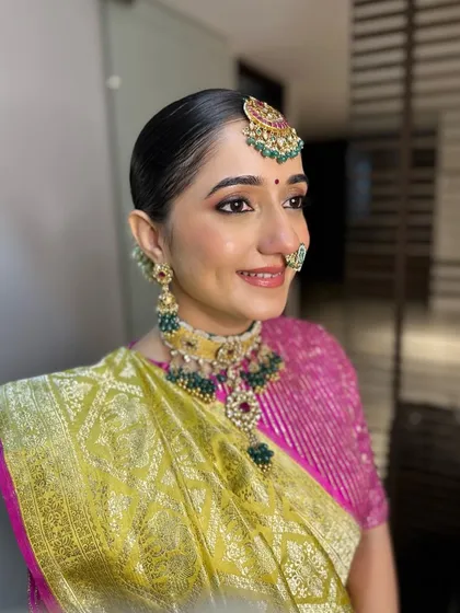 Archi's profile, highlighting her elegant posture and the beautiful details of her jewelry. The clean, simple makeup allows her traditional accessories to truly shine.