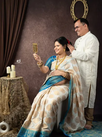 A playful moment during a traditional saree shoot. The husband helps his wife with her hair, a small, intimate gesture that I love to capture.