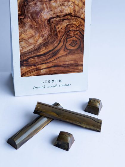 Capturing the grain of wood in chocolate. Our "Lignum" bonbons are a testament to the detailed hand-painting skills our students develop.