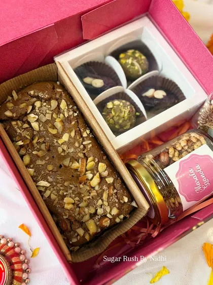 The 'Diwali Delight Box' with a tea cake, a jar of masala granola, and a small box of my signature Indian fusion sweets.