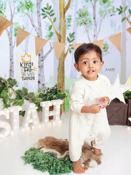 Standing tall and proud on his first birthday. The light-up letters spelling his name add a wonderful personal touch to the photoshoot.