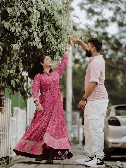 The couple sharing a dance on the sidewalk, a moment of spontaneous romance.