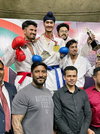 On top of the podium at the India Open. Celebrating with fellow competitors and coaches is a mark of respect and sportsmanship that I emphasize in my coaching.