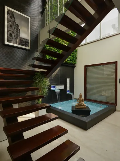 In the Gupta Residence, I integrated this tranquil indoor waterbody beneath a floating wooden staircase. This feature brings a sense of calm and nature into the core of the home, combining natural elements with contemporary architectural sophistication.