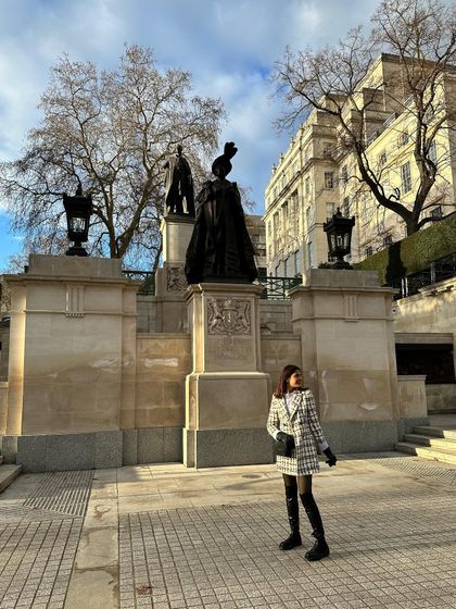 Exploring London on a crisp day. My tweed coat dress and boots are a stylish and practical choice for sightseeing around the city's historic monuments.