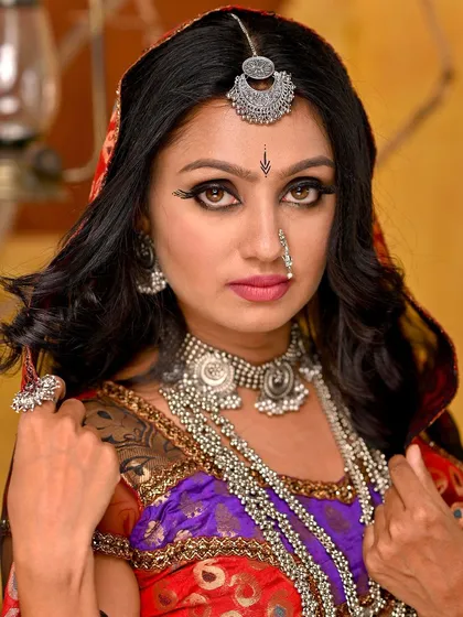 A close-up portrait from the Rajasthani series, highlighting the dramatic eye makeup and traditional nose ring. The lighting is carefully controlled to sculpt the face.