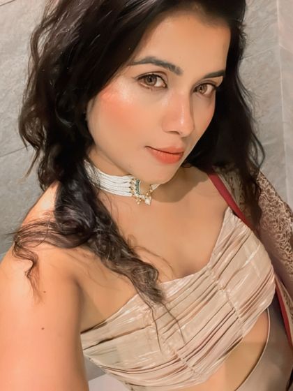 A close-up selfie highlighting the client's festive makeup and the intricate design of the white pearl choker. It sits perfectly and adds a touch of sophistication.