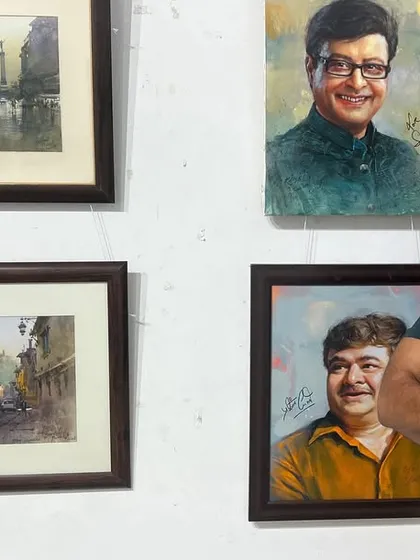 A happy moment, standing with some of my framed portraits and landscapes at an exhibition.