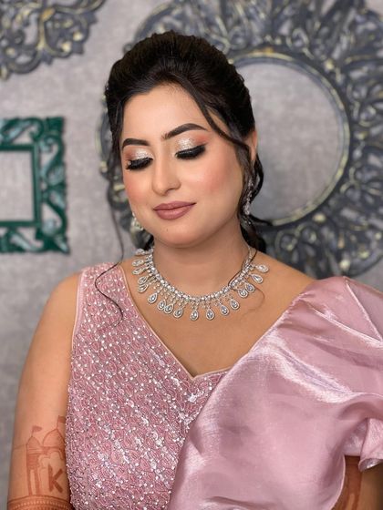 Divisha's engagement look, featuring soft, glittery eyes and a nude pink lip. The overall look is romantic and elegant.