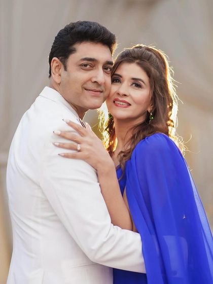 A happy, smiling portrait of the couple. The makeup enhances her features and gives her a joyful, radiant glow.