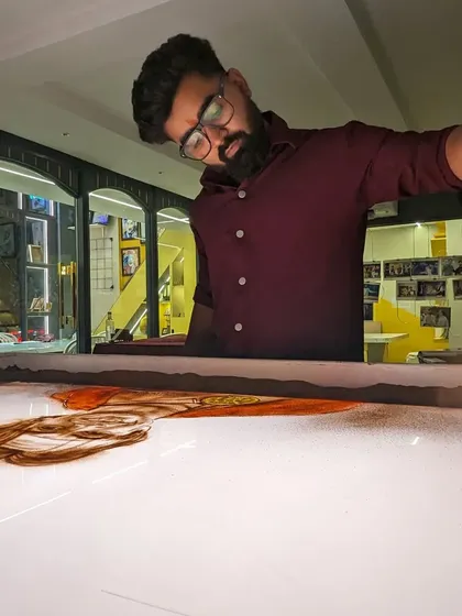 A wide shot of me working on the Neeraj Chopra portrait in my studio.