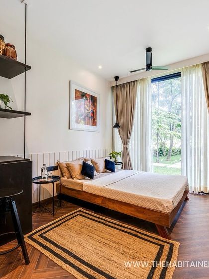 The full view of the 240 sq. ft. pod's interior, showing how a bed, kitchenette, and shelving can be elegantly arranged in a small space.