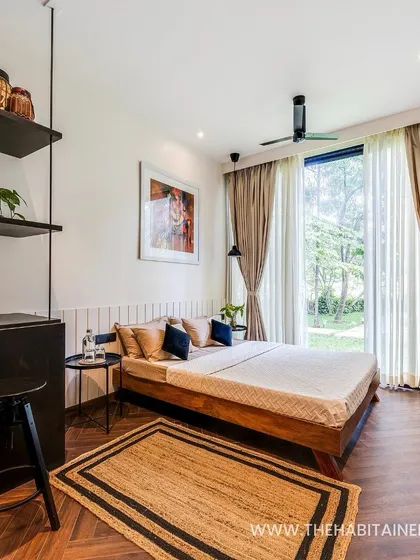 The full view of the 240 sq. ft. pod's interior, showing how a bed, kitchenette, and shelving can be elegantly arranged in a small space.