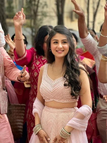 The bride enjoying her Haldi celebration. Her makeup is subtle and enhances her natural beauty, letting her joy be the focus.
