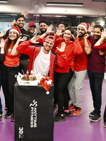 A happy group photo with the Christmas cake. Celebrating festivals together strengthens our bond as a fitness family.