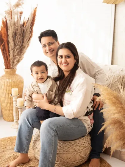 A beautiful family portrait in our bohemian-themed studio setup. The natural textures and warm tones create a cozy and inviting atmosphere.