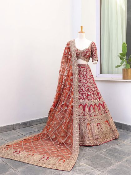 The full red floral embroidered lehenga with its net dupatta beautifully draped. A perfect example of a classic yet fresh bridal look.