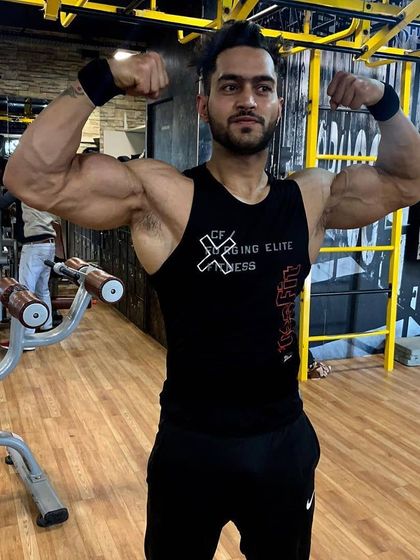 The last few reps are what separate a champion from everyone else. Hitting a double bicep pose to show the arm and chest development that comes from pushing through the pain barrier.