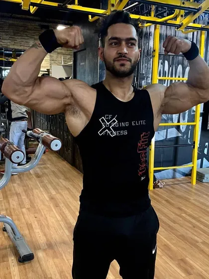 The last few reps are what separate a champion from everyone else. Hitting a double bicep pose to show the arm and chest development that comes from pushing through the pain barrier.