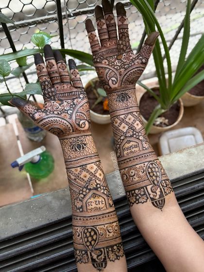 A full view of the engagement mehendi, showing how the design flows from the palms up to the elbows.