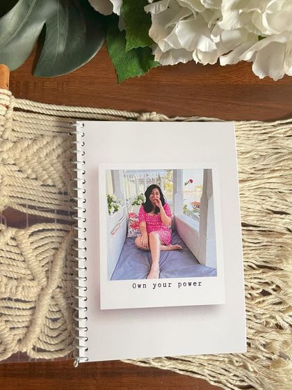 The cover of the planner booklet can also be personalized with a photo and a powerful quote like 'Own your power'.