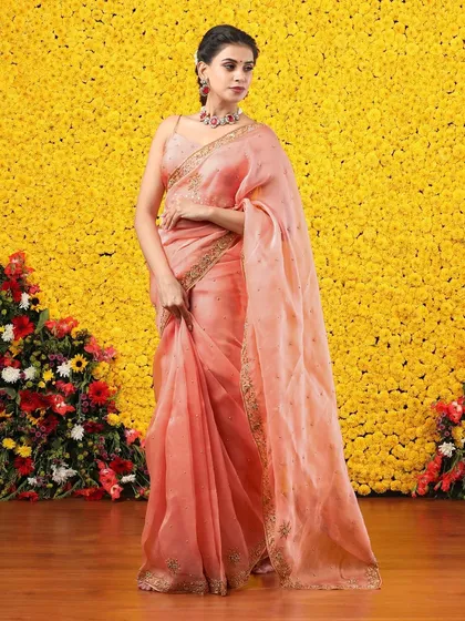 Another full view of the peach organza saree, a timeless and elegant addition to any wardrobe.