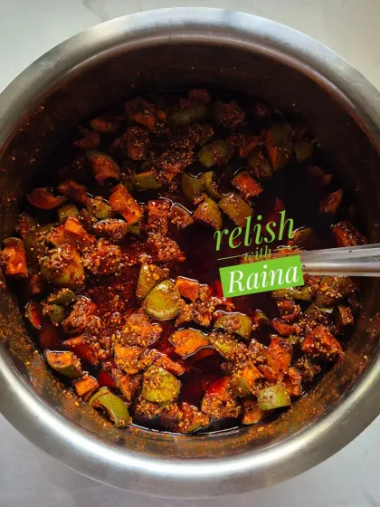 Here you can see my classic Spicy Khatti Kairi Pickle being prepared. I use Ladua kairi, a type of raw mango known for its sour taste and fleshy pulp, and mix it with my family's secret masala blend. This picture shows the pickle just after mixing, before it's left to mature and let the flavours deepen.
