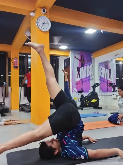 A student holds a variation of Sarvangasana (Shoulder Stand), a powerful inversion that benefits the entire body. We build up to such poses with careful instruction.