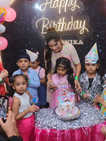 The birthday girl and her friends gather around the unicorn cake for the big moment. The excitement and anticipation are what make birthdays so special.