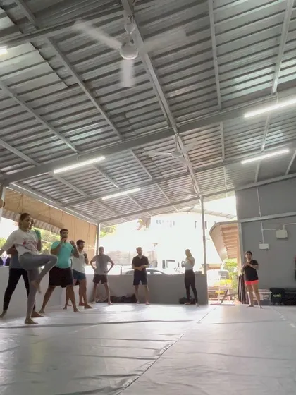 The class in the middle of a dynamic warmup, getting ready for the session.