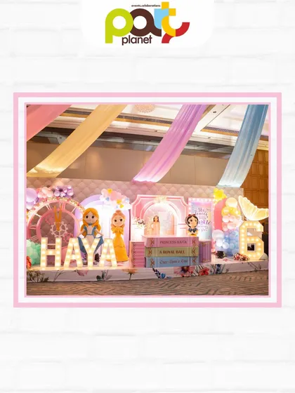 A stunning stage setup featuring storybook props, marquee letters, and beloved princess characters, perfect for a fairytale birthday.