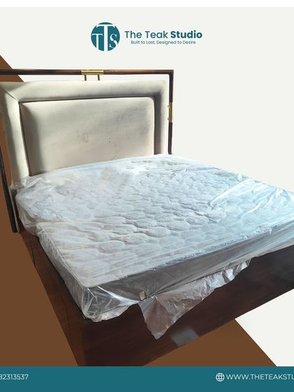 A simple and elegant bed design with a solid wood frame and a clean, upholstered headboard, shown here just after delivery.