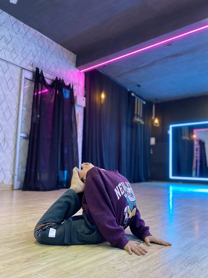 A student performs an advanced backbend, demonstrating the incredible flexibility we cultivate through our gymnastics training. This skill is vital for contemporary and acrobatic dance styles.