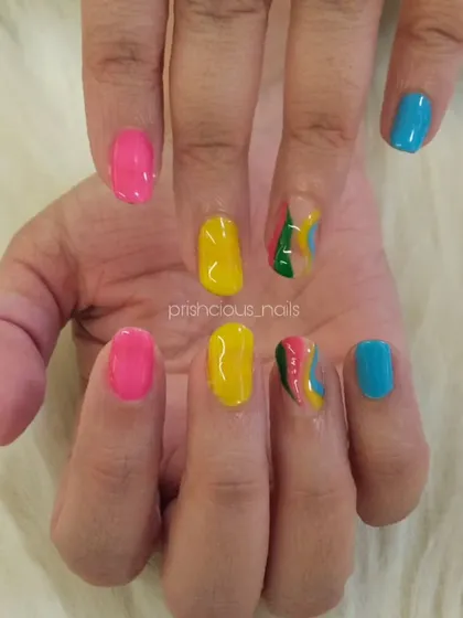 Bright and colorful vacation nails. This set features a mix of hot pink, yellow, and blue, with a fun multi-color swirl accent nail.