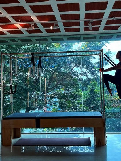 It does not matter who you are, we all need a strong core. This client uses the resistance bands on the Cadillac to challenge her balance and core stability.