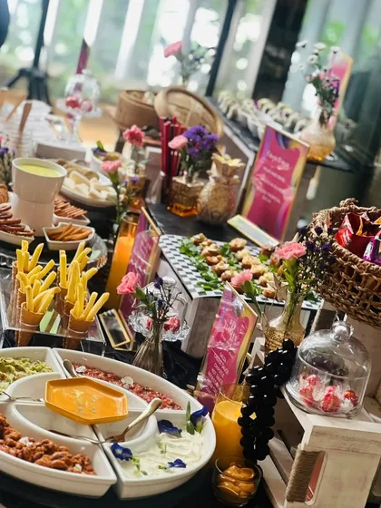 A feast of flavors and colors. This grazing table showcases our versatility, featuring everything from french fry cones and dip platters to bite-sized appetizers and fresh salads.