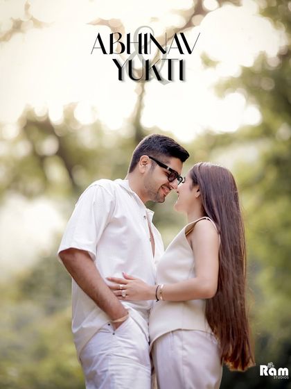 A soft, dreamy portrait of a couple in a lush green forest setting. The focus is on their gentle expressions and the romantic, sun-filled atmosphere of their outdoor pre-wedding shoot.