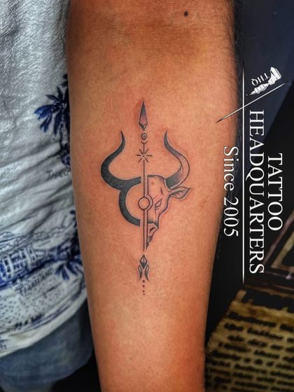 A unique design combining a bull's head, representing Taurus or Nandi, with a spear, symbolizing strength and protection.
