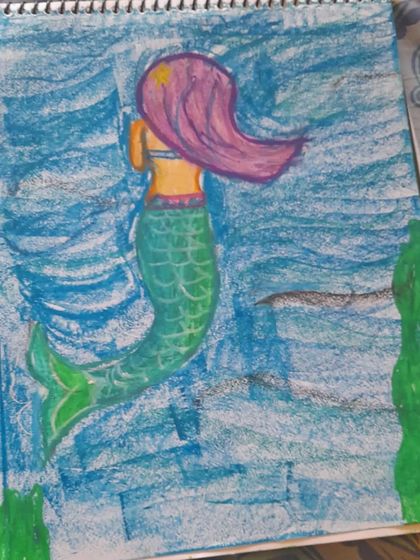 Ishaani, a 4th standard student, drew this mermaid in the ocean using oil pastels. The drawing shows a good sense of movement in the water and hair.
