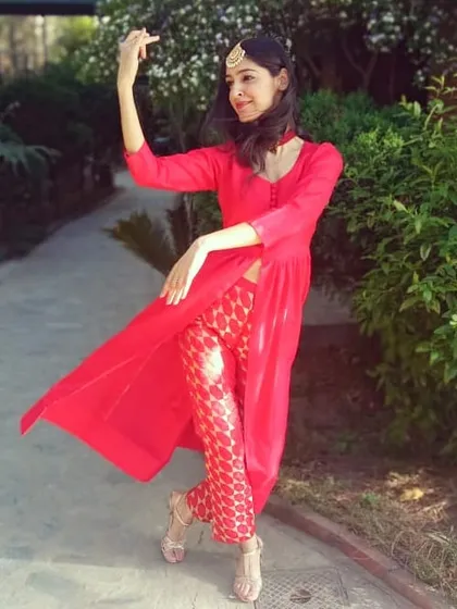 A moment of pure joy, striking a classical Bharatanatyam mudra outdoors. This pose captures the expressive storytelling that is at the heart of Indian classical dance, a passion I bring into every class.