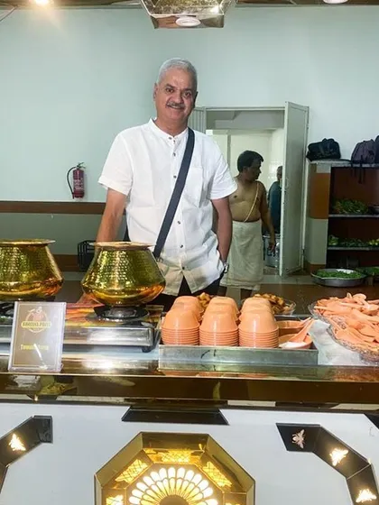 I believe in being hands-on with every event. Here I am at one of our catering stations, ensuring every detail is just right. The traditional hammered brass pots are not just for show; they are part of our commitment to serving authentic, home-style food that reminds you of a mother's cooking.