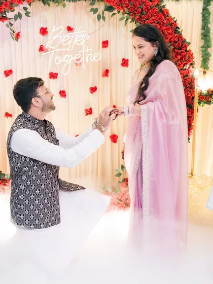 The moment it becomes official. We love capturing the ring exchange, especially with such a beautiful setup. The soft lighting and "Better Together" sign made this engagement ceremony feel magical.