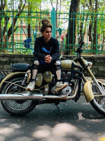 A graduate sits on her bike, a picture of calm and control. She has found her balance, both on and off the road.