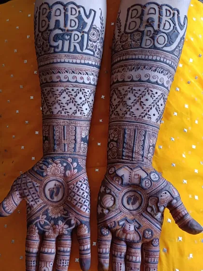 This is the full view of the "Baby Girl" and "Baby Boy" mehendi design. It shows how a theme can be carried from the palms all the way up the arms for a complete and celebratory look.
