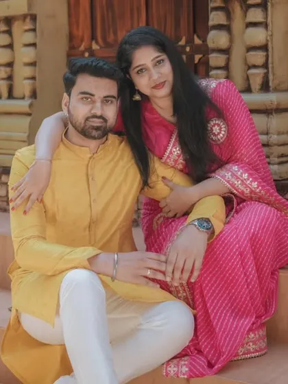 A close, affectionate pose on the steps of a heritage-style location. This photo highlights the couple's connection and their beautiful traditional outfits.