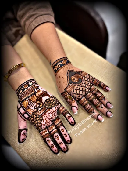 A great example of complementary designs for two hands, one with a peacock and the other with an elephant motif.