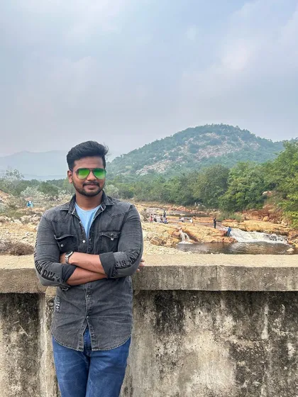 A portrait with the beautiful landscape of the Hogenakkal area in the background.