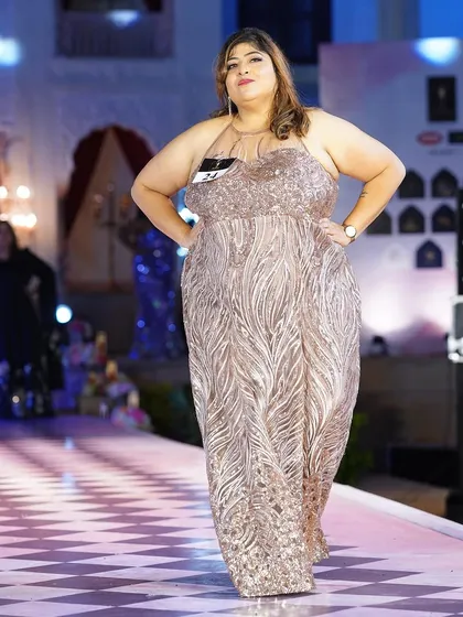 The rose gold sequined plus-size gown, looking absolutely stunning as it catches the light.