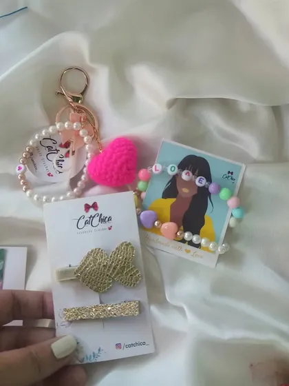 Another look at our Valentine's gift set, featuring a 'LOVE' bracelet, a crochet heart keyring, and a set of our elegant gold shimmer hair clips.